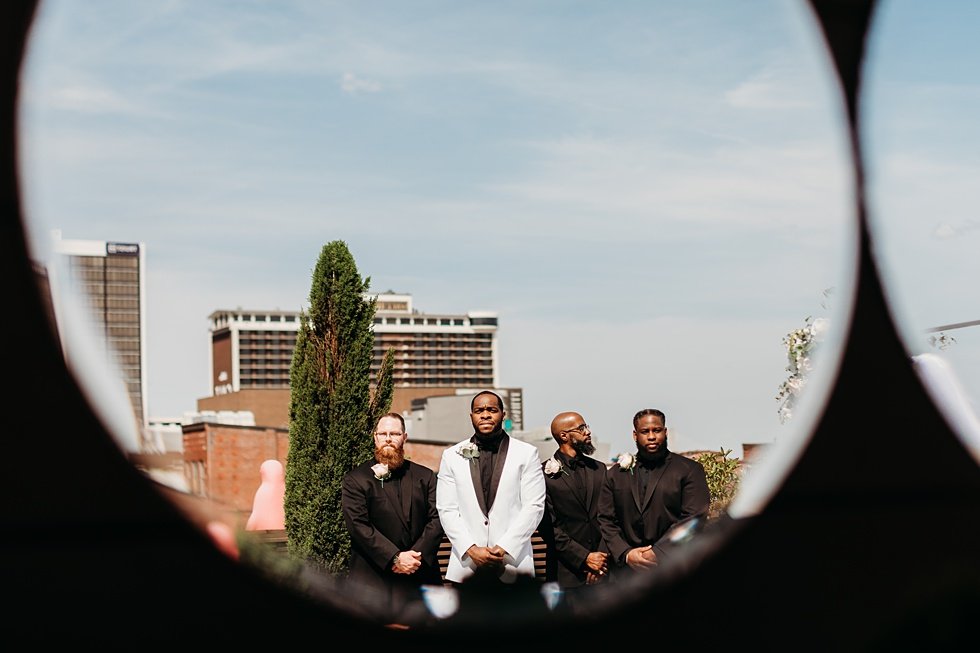  Groom posing with groomsmen. Rooftop wedding and reception at 21C Hotel Louisville 