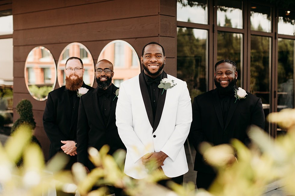  Groom posing with groomsmen. Rooftop wedding and reception at 21C Hotel Louisville 