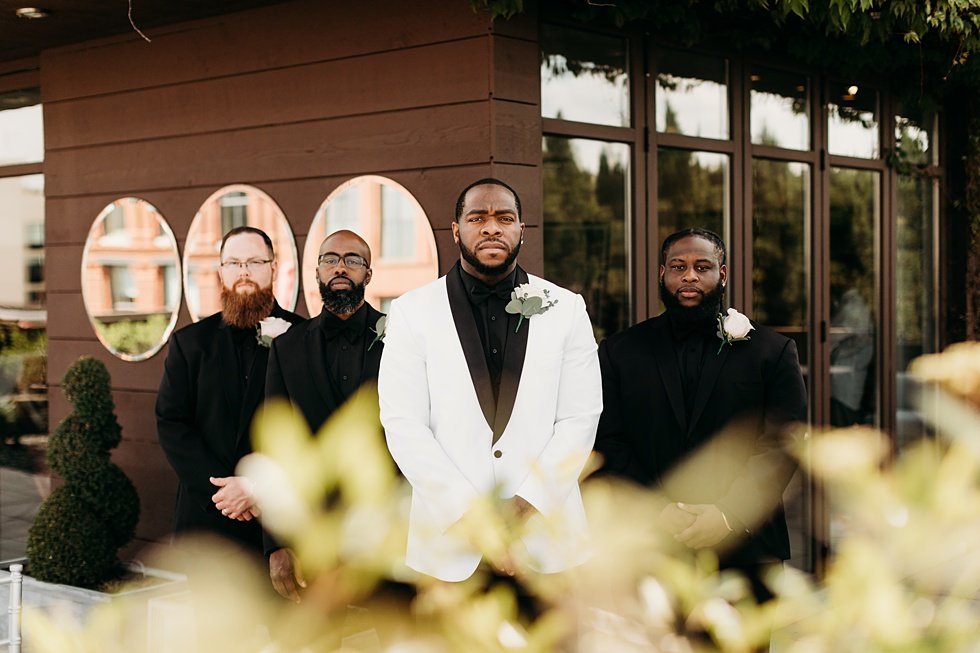  Groom posing with groomsmen. Rooftop wedding and reception at 21C Hotel Louisville 