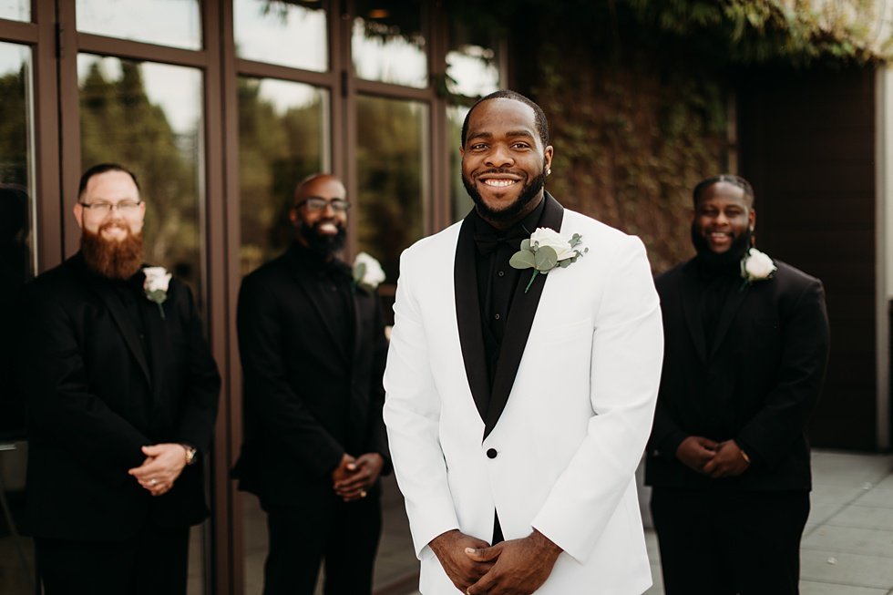  Groom posing with groomsmen. Rooftop wedding and reception at 21C Hotel Louisville 