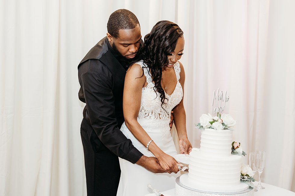  Couple cutting cake at 21c. Wedding reception at 21c Hotel Louisville. Rooftop wedding and reception at 21C Hotel Louisville 