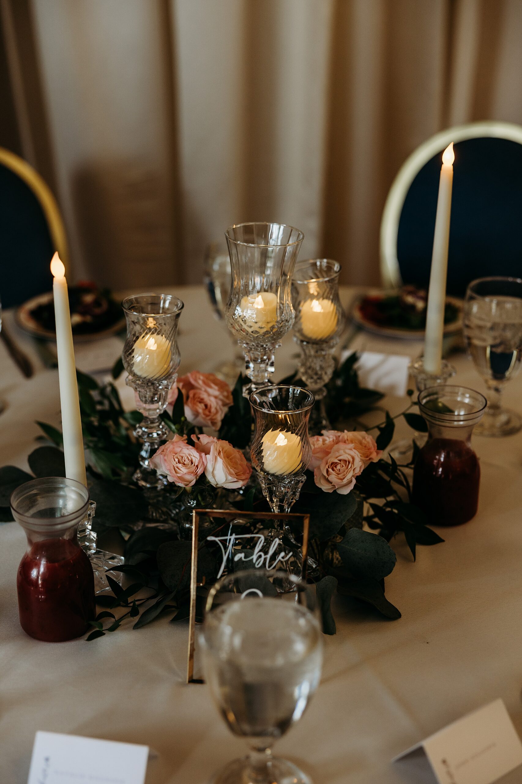Candlelit table details at a Gardencourt wedding reception with floral accents