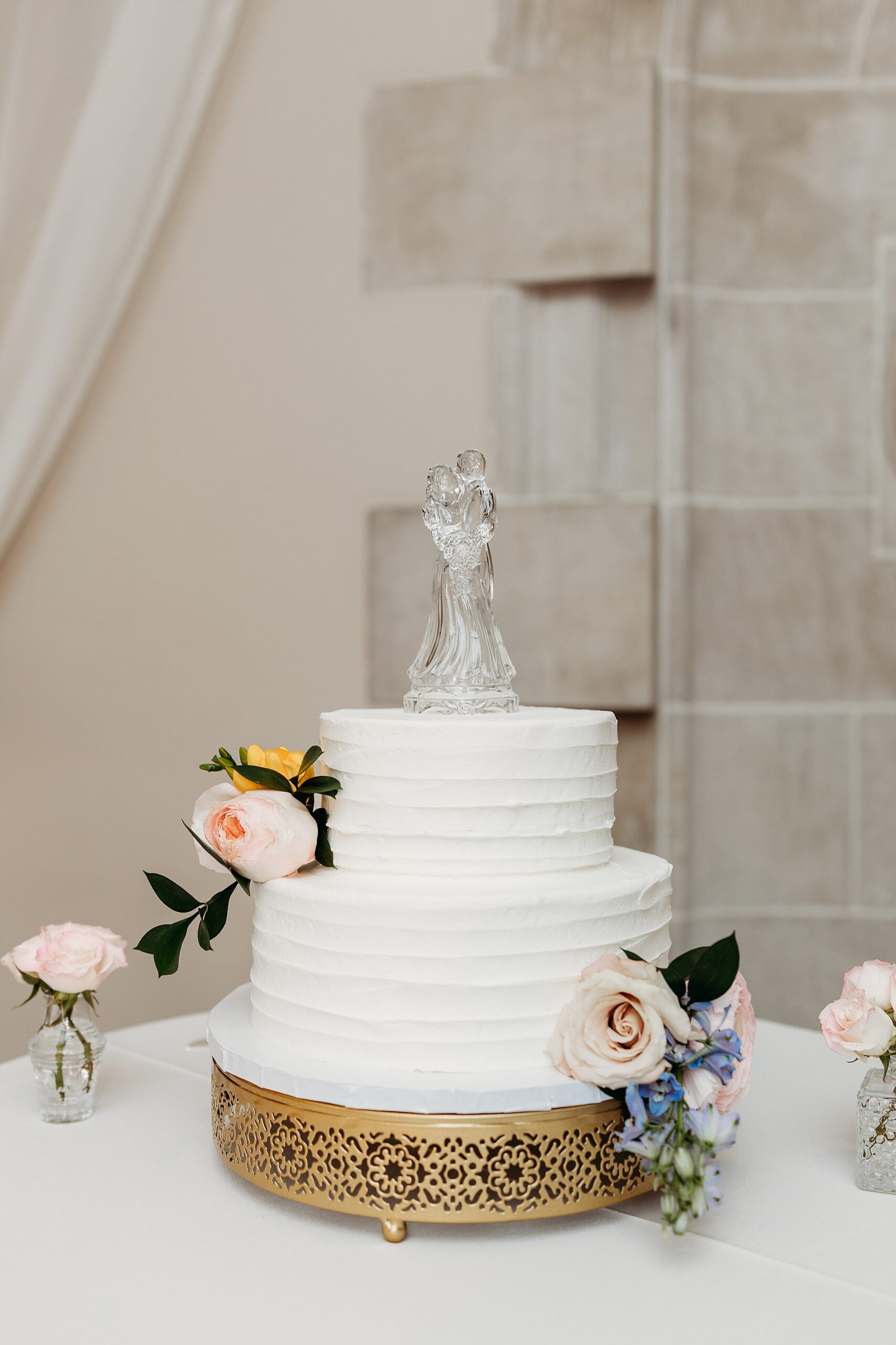 Wedding cake display during a Gardencourt wedding reception with floral details