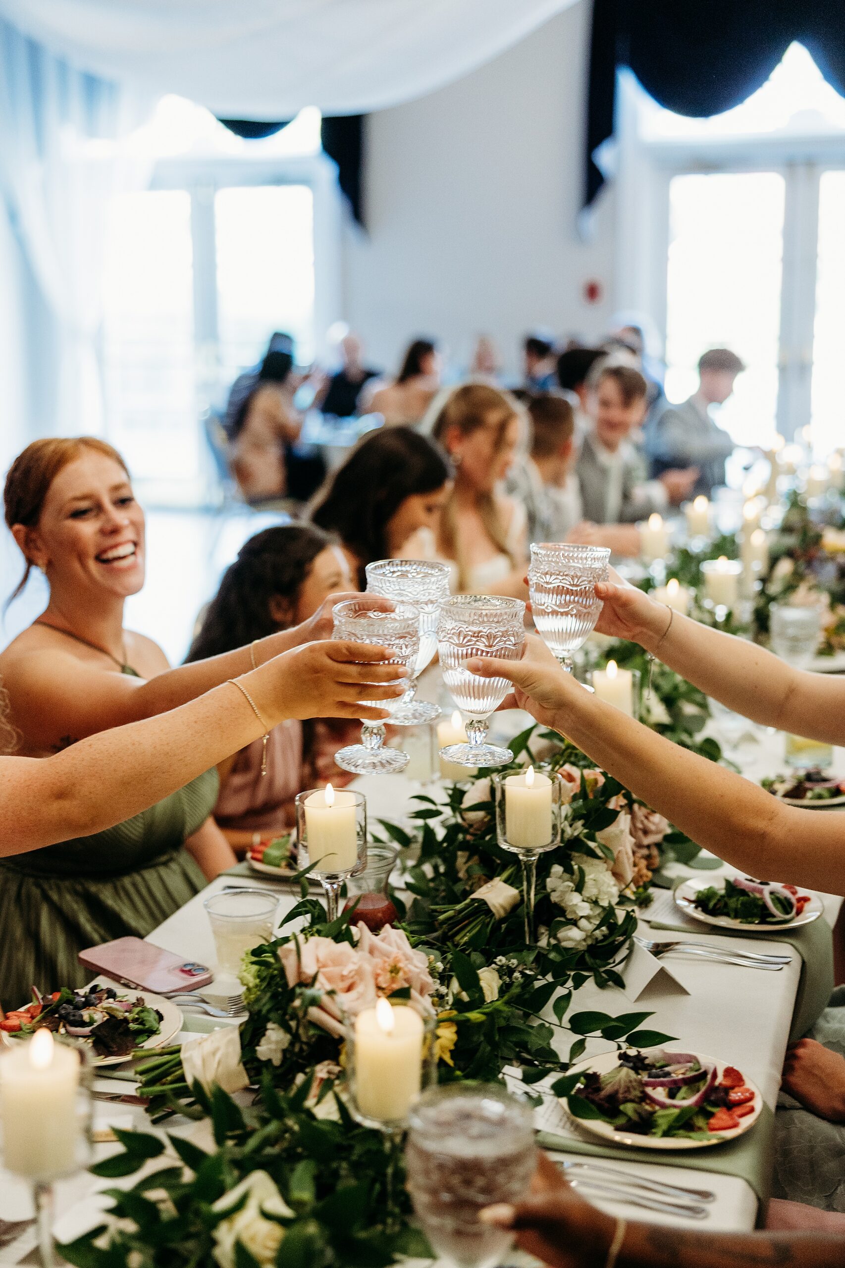 Guests raising glasses during a toast at a Gardencourt wedding reception