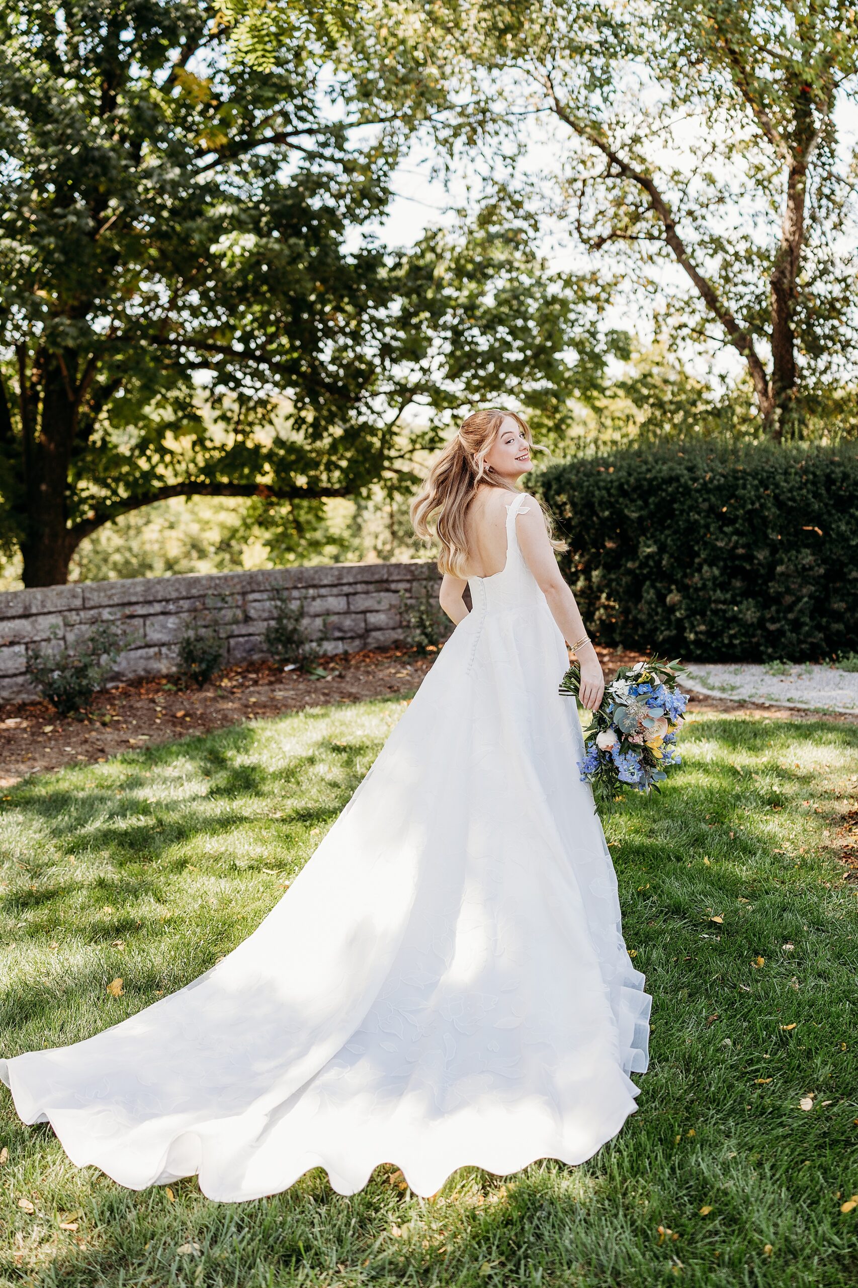 Bride twirling her dress during a Gardencourt wedding reception on the grounds