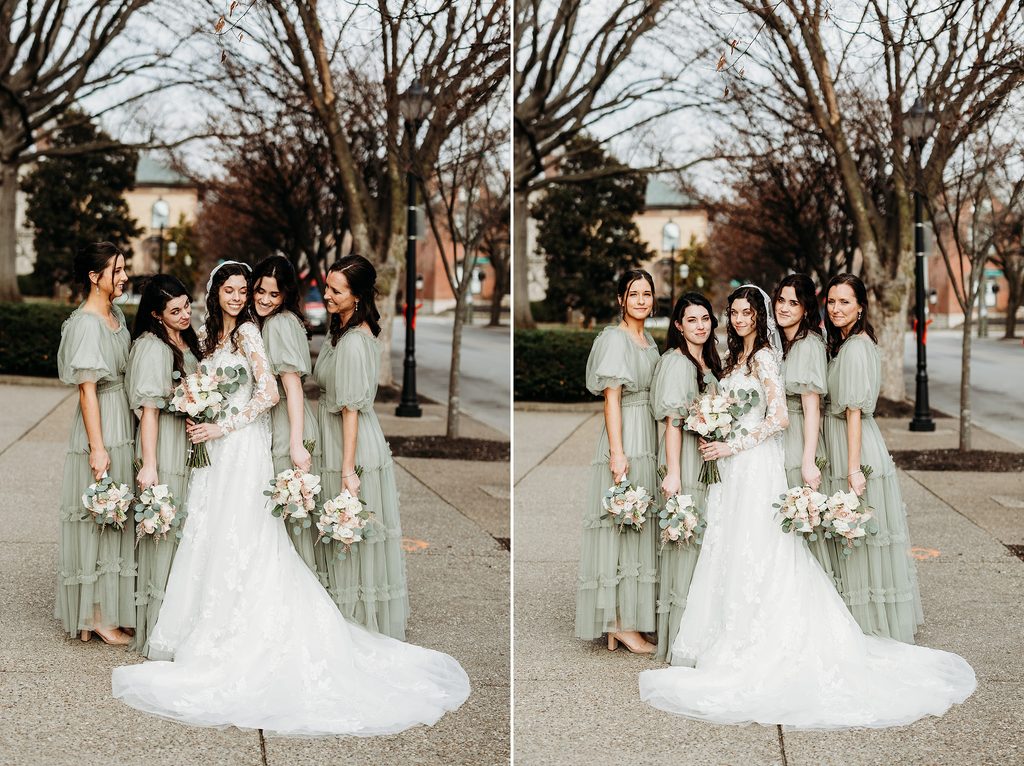 Bride posing with bridesmaids in sage green dresses and floral bouquets.