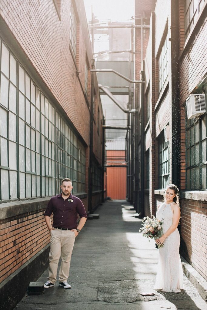 Buffalo Trace Distillery wedding portrait in industrial brick alleyway with bride and groom between historic warehouse buildings.