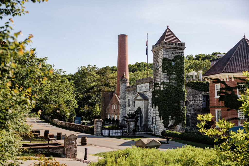 Castle & Key Distillery exterior with ivy-covered stone buildings and historic towers.