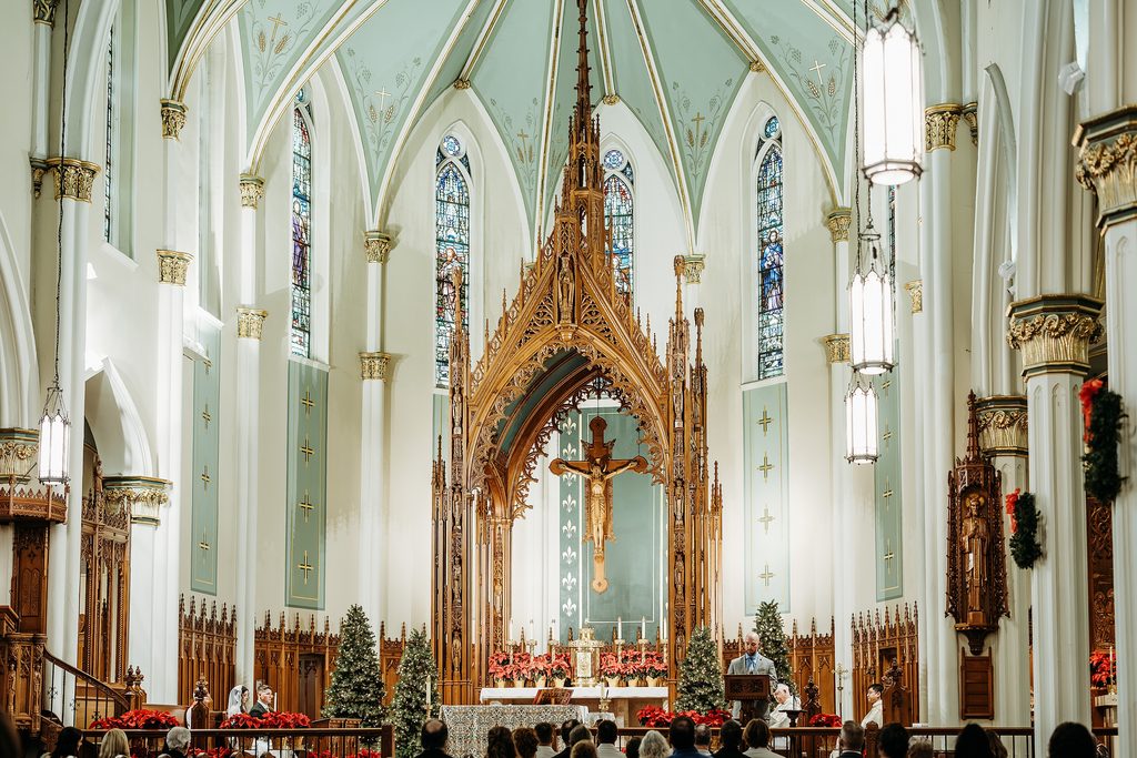 Catholic wedding Mass inside an ornate Louisville, KY church decorated for Christmas.