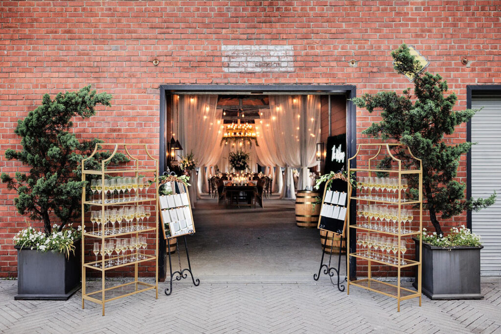 Castle & Key Shook Building reception entrance with champagne display, seating chart, and draped reception decor.