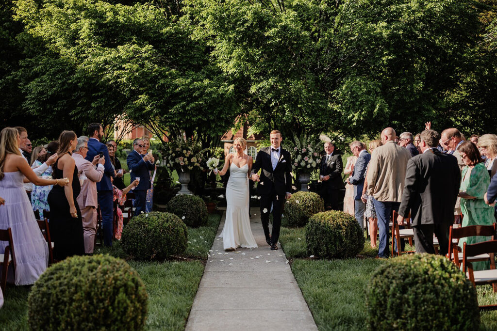 Castle & Key Sunken Garden wedding recessional with guests celebrating the newlyweds.