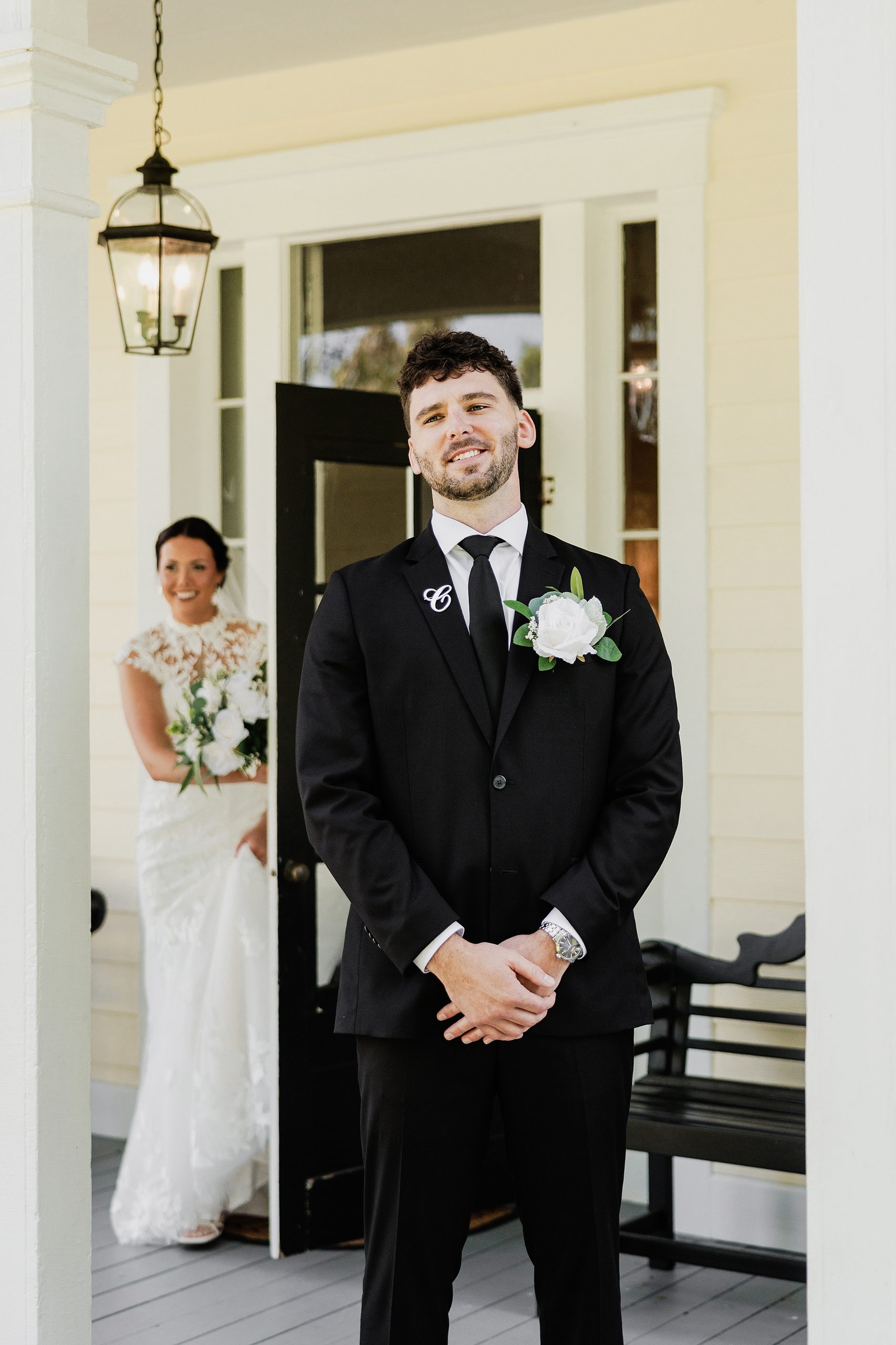 Groom smiles while waiting for his bride during their wedding first look.