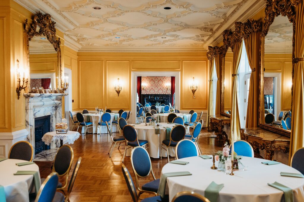 Garden Court grand reception room with marble fireplace, ornate mirrors, and elegant wedding reception tables.
