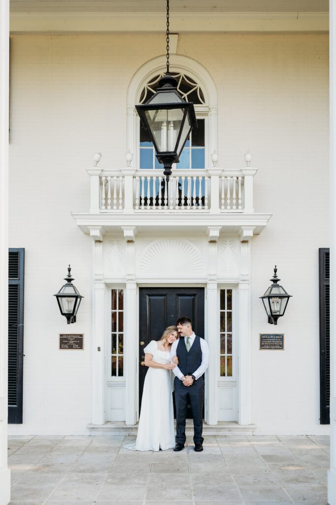 Front entrance portrait of a bride and groom at the historic Louisville home.