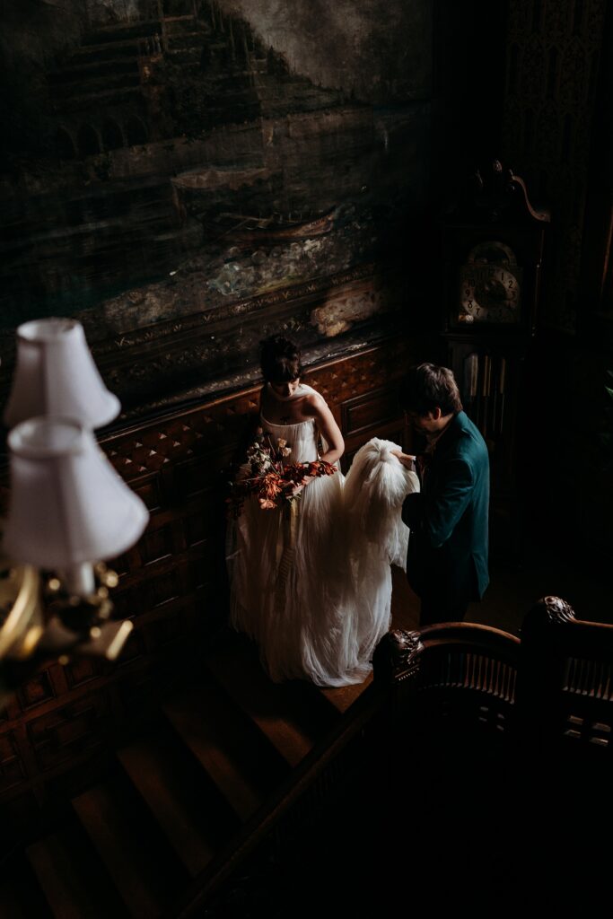 Couple shares a quiet moment on the grand staircase