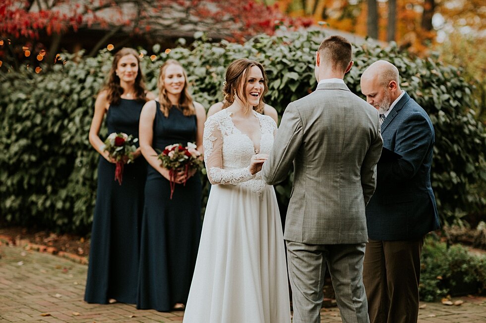 Bride & Groom exchange rings during their outdoor fall wedding in Louisville, KY