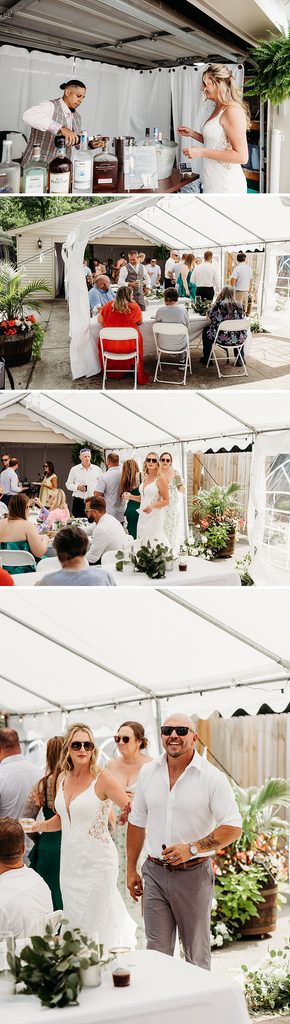 Bride and groom mingle with guests beneath a white tent during their casual backyard wedding reception.