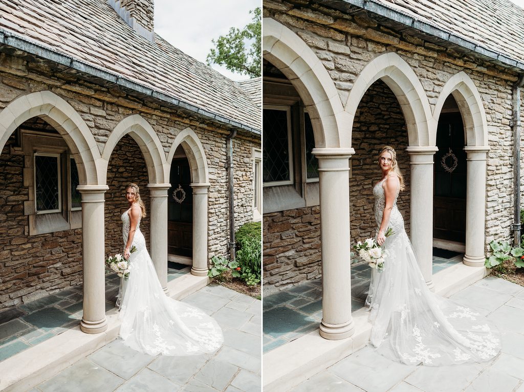 Bride in a lace wedding dress posing with her bouquet beneath stone arches at Duncan Memorial Chapel.