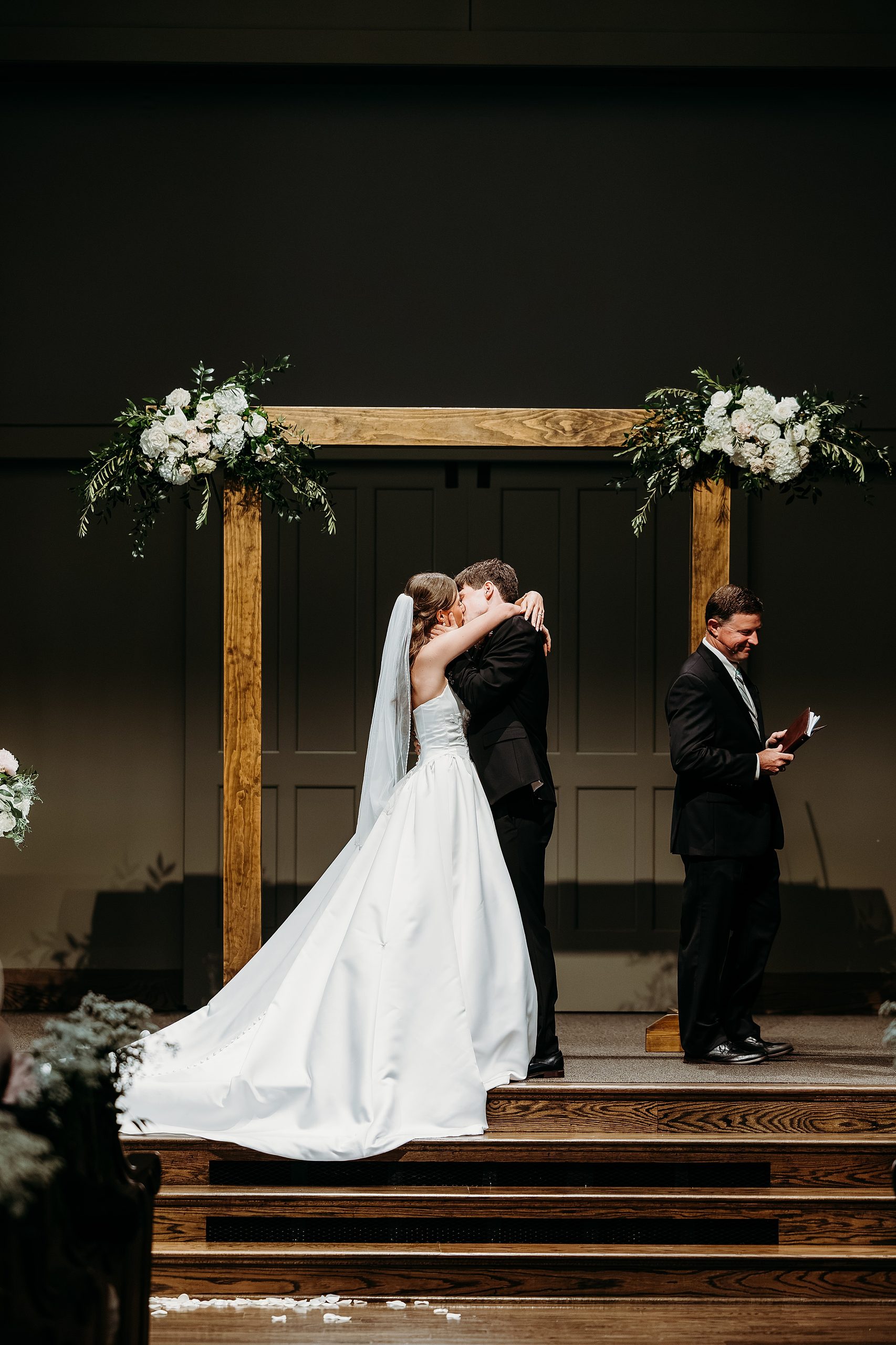 Bride and Groom kiss at the end of their wedding ceremony.