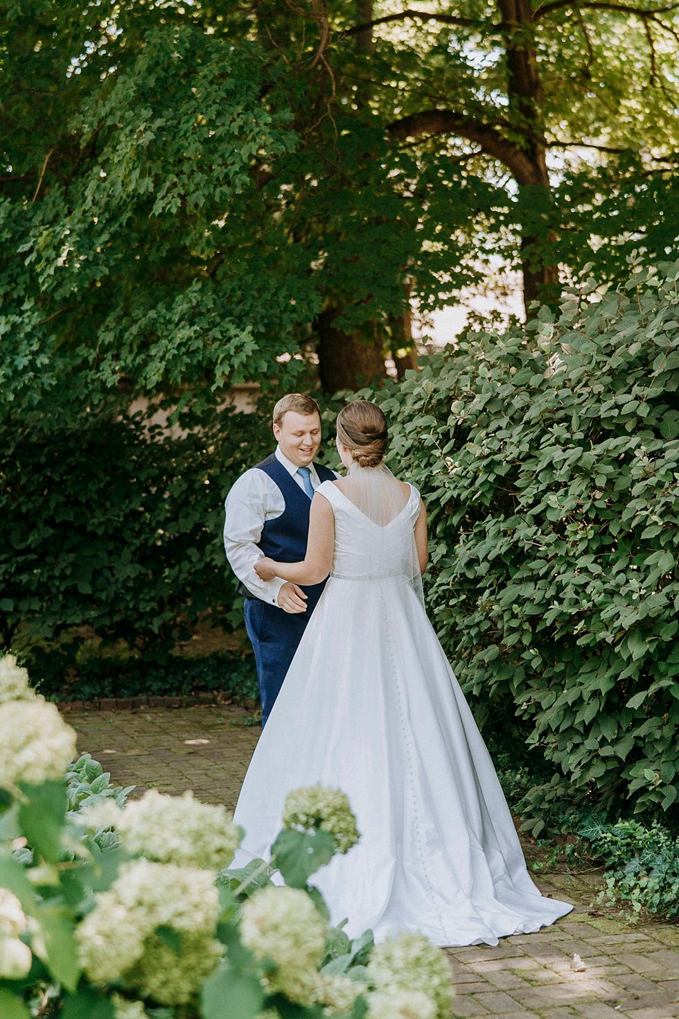Bride and Groom have their first look in the gardens at Farmington.