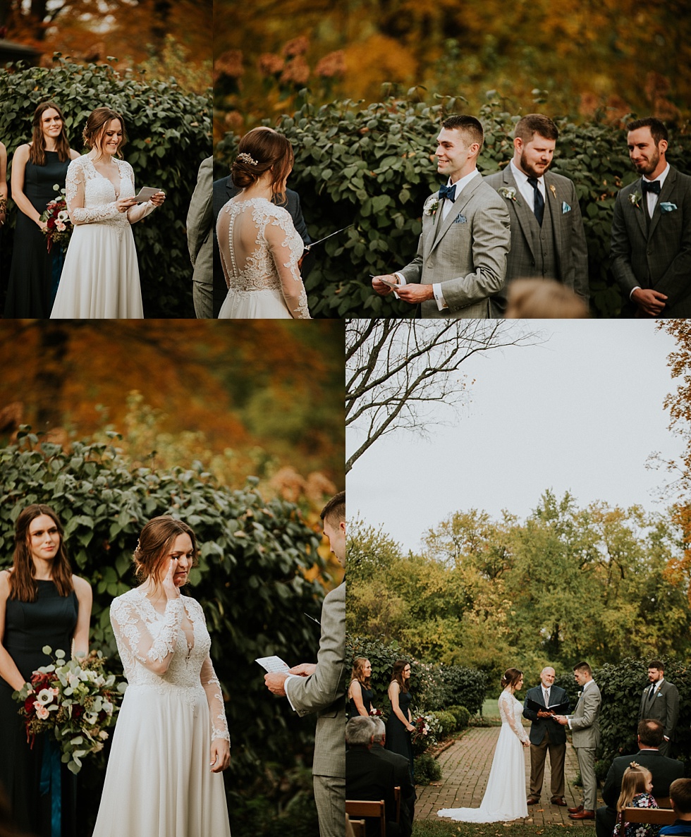 Bride wipes away tears while exchanging vows during an autumn garden wedding ceremony.